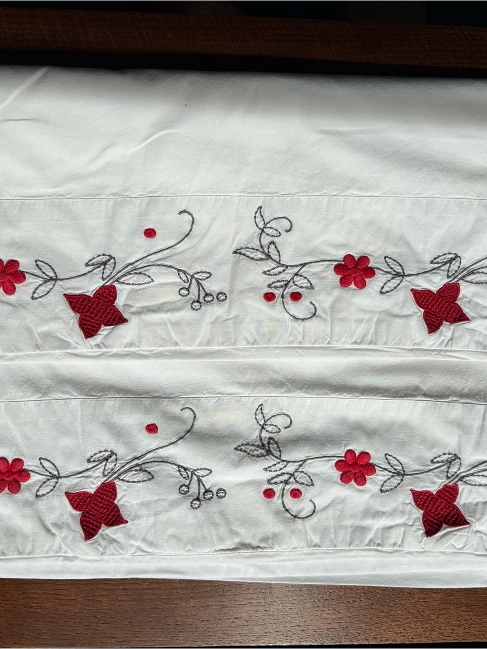 Pair of white cotton pillowcases with red embroidery